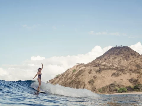 Woman in Lombok Indonesia Longboard surfing slide